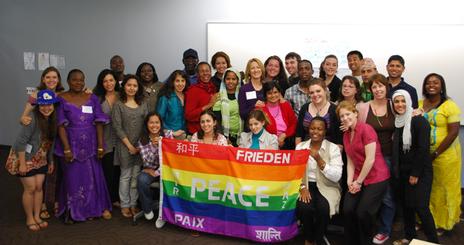 2011 Summer Professional Training Program participants pose for a photo with the Peace Flag.